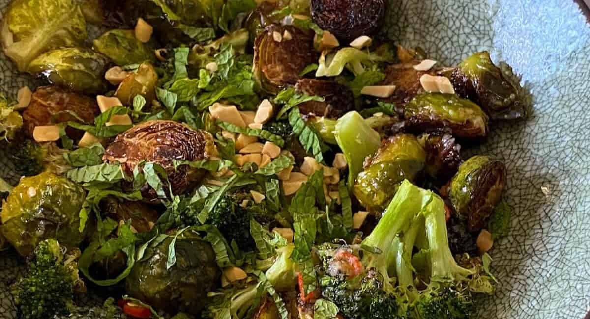Brussel sprouts and broccoli salad in a blue bowl.