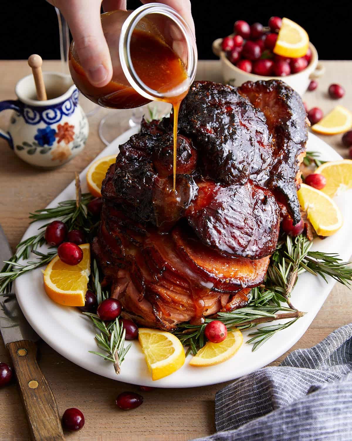 Overhead image of honey glaze for ham on white dish with garish.