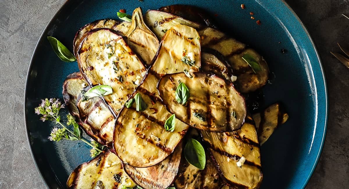 Overhead image of grilled and marinated Italian eggplant antipasto.