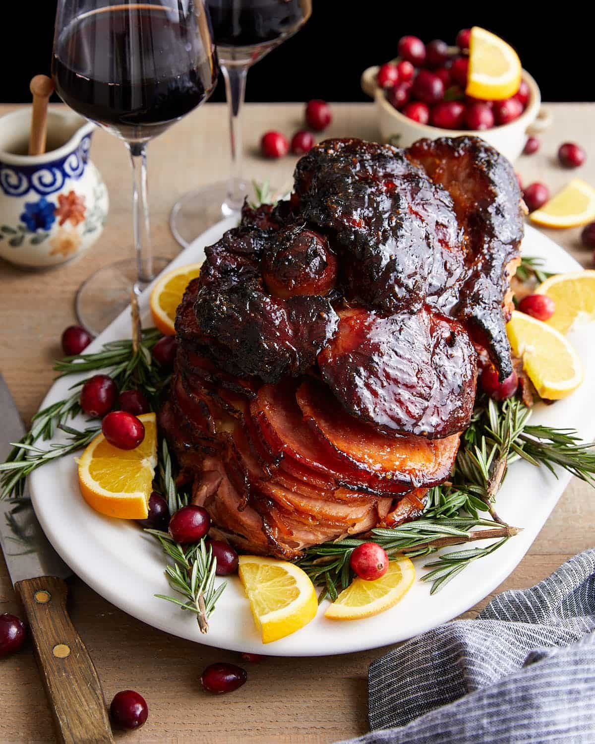 Image of spiral ham on white plate with garnish.