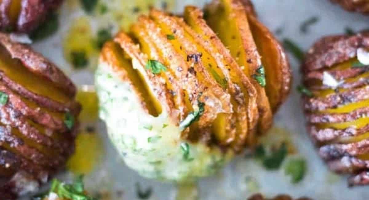 Overhead image of hasselback potatoes with garlic and herb aioli.