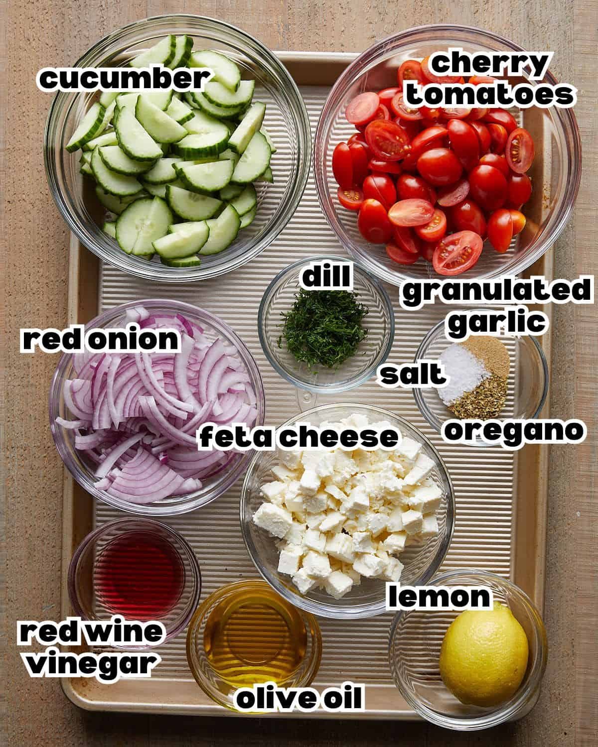 Overhead image of ingredients needed to make cucumber tomato and feta salad.