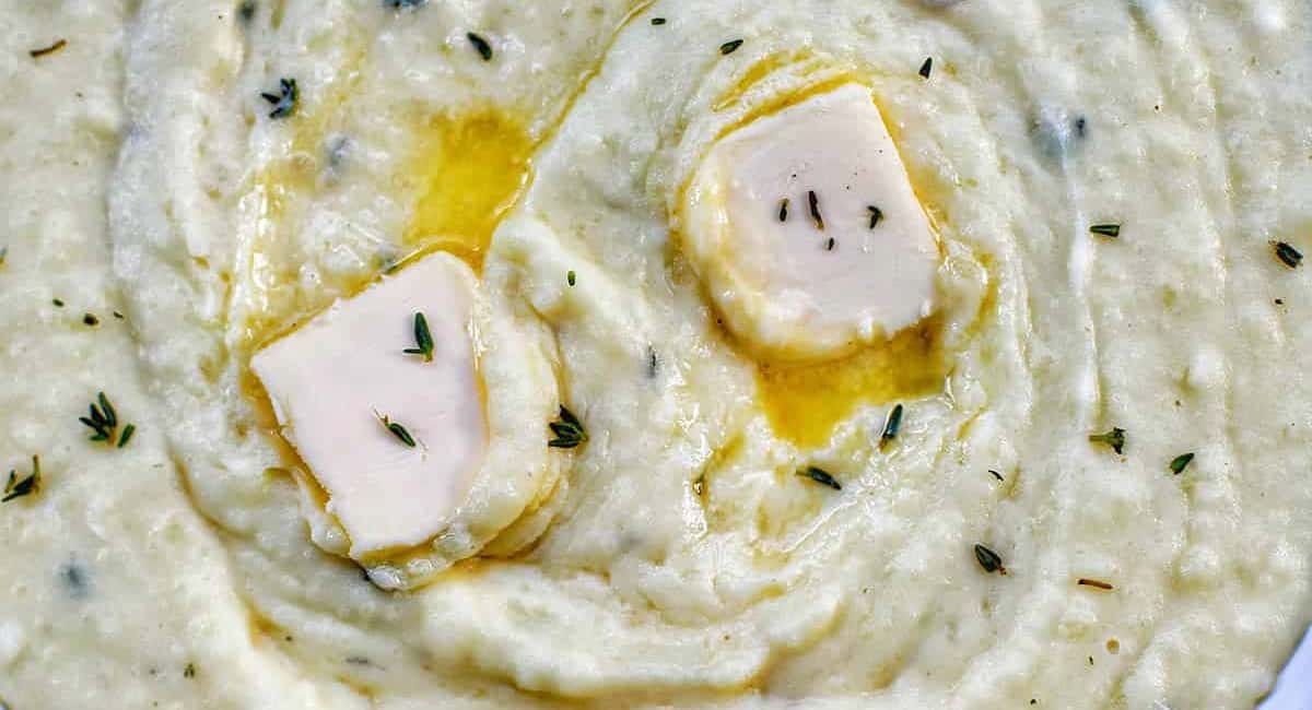 Overhead image of instant pot garlic mashed potatoes with garnish.