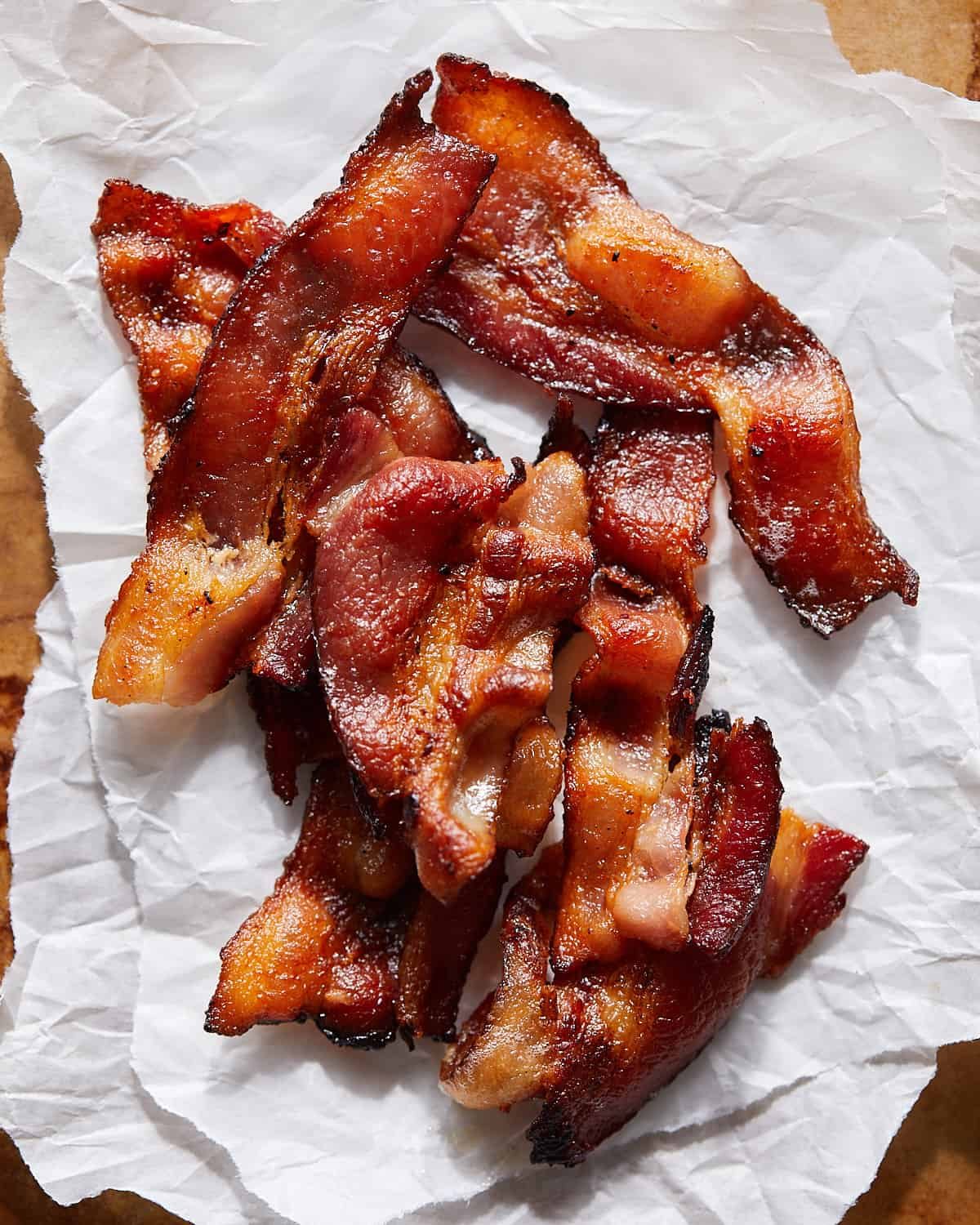 Instant pot bacon pieces on parchment paper.