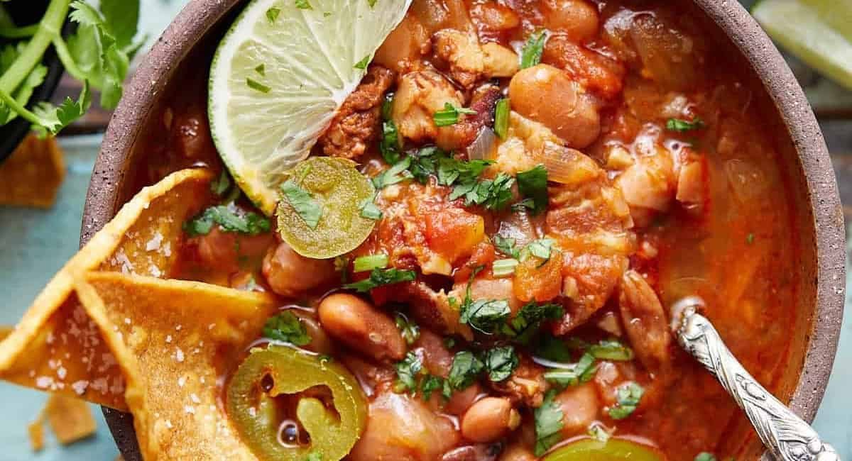 Overhead image of instant pot charro beans with garnish.