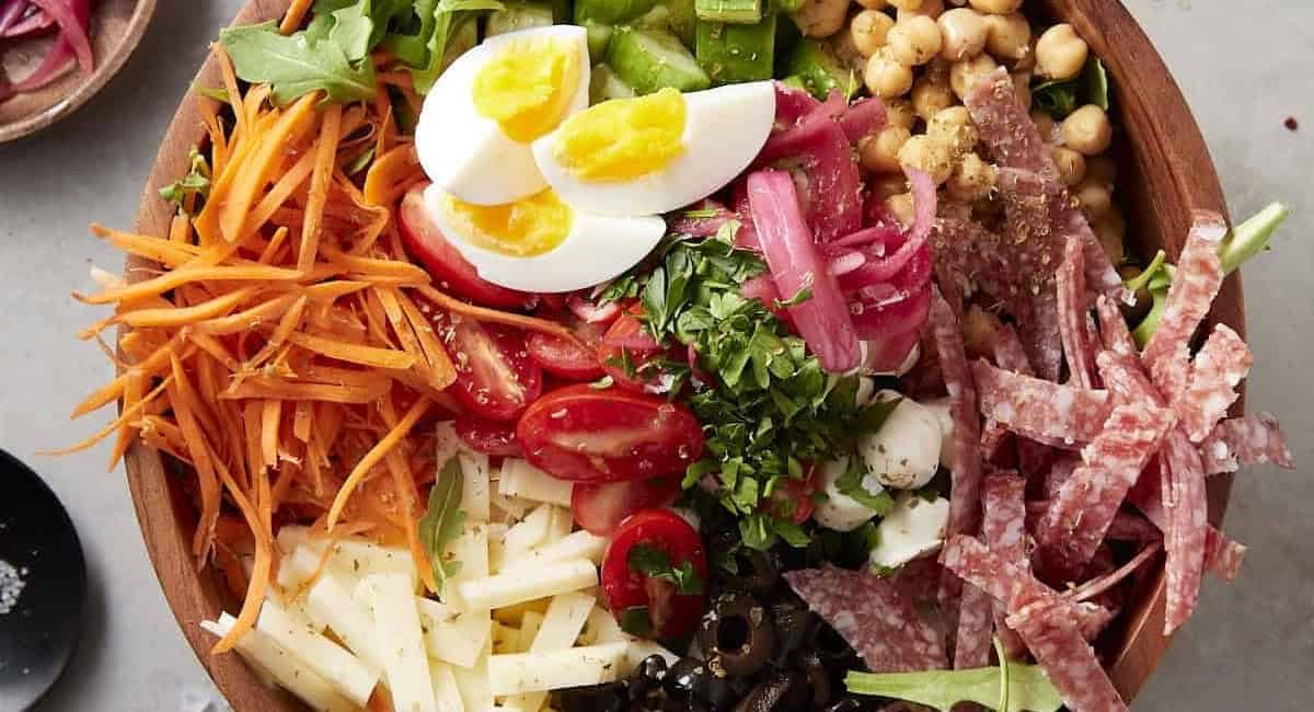 Overhead image of Italian chopped salad in brown bowl.