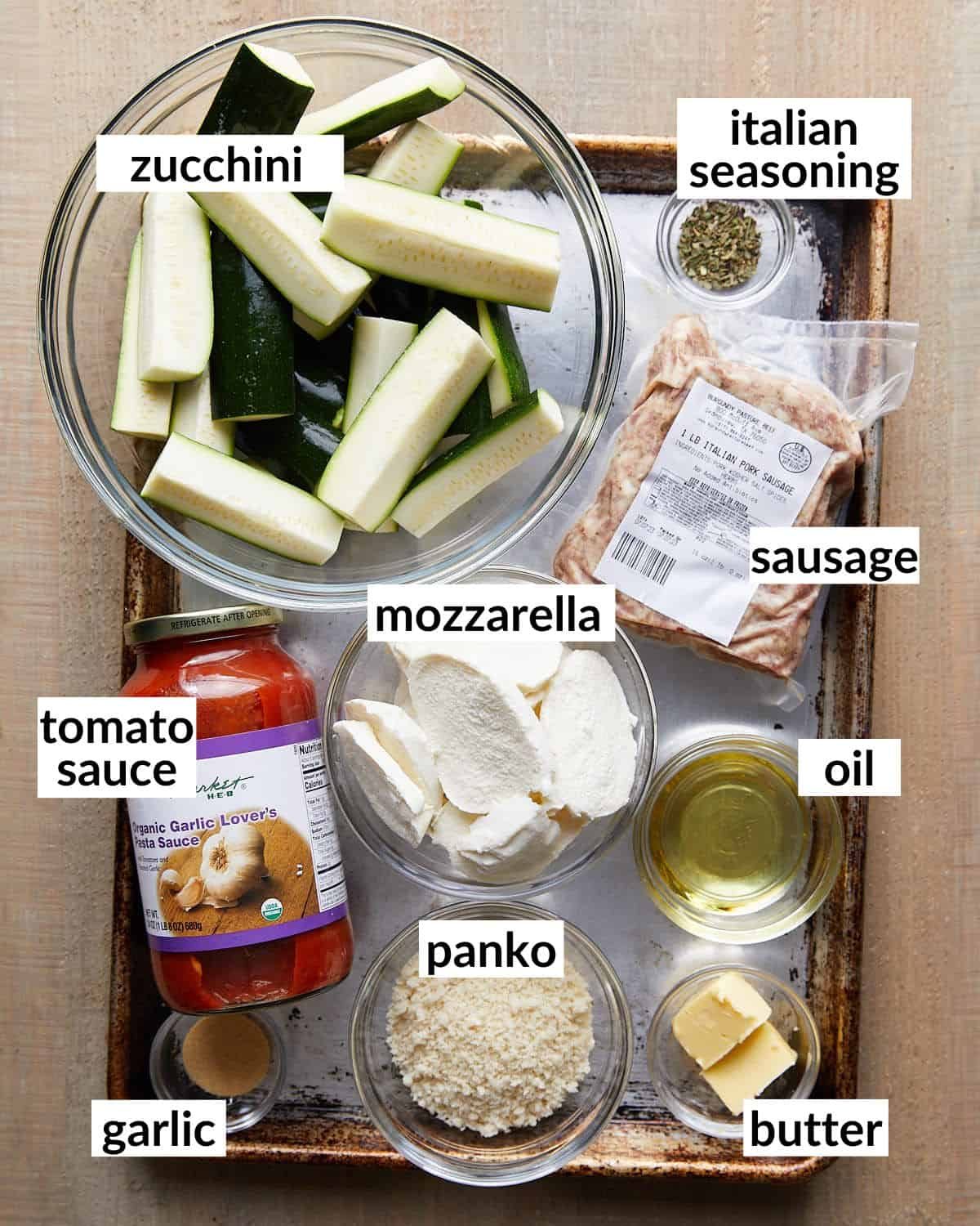 Overhead image of ingredients needed to make Italian baked zucchini with tomato sauce and cheese.