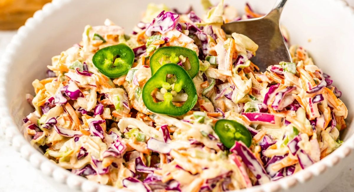 Overhead image of jalapeno coleslaw in white bowl.