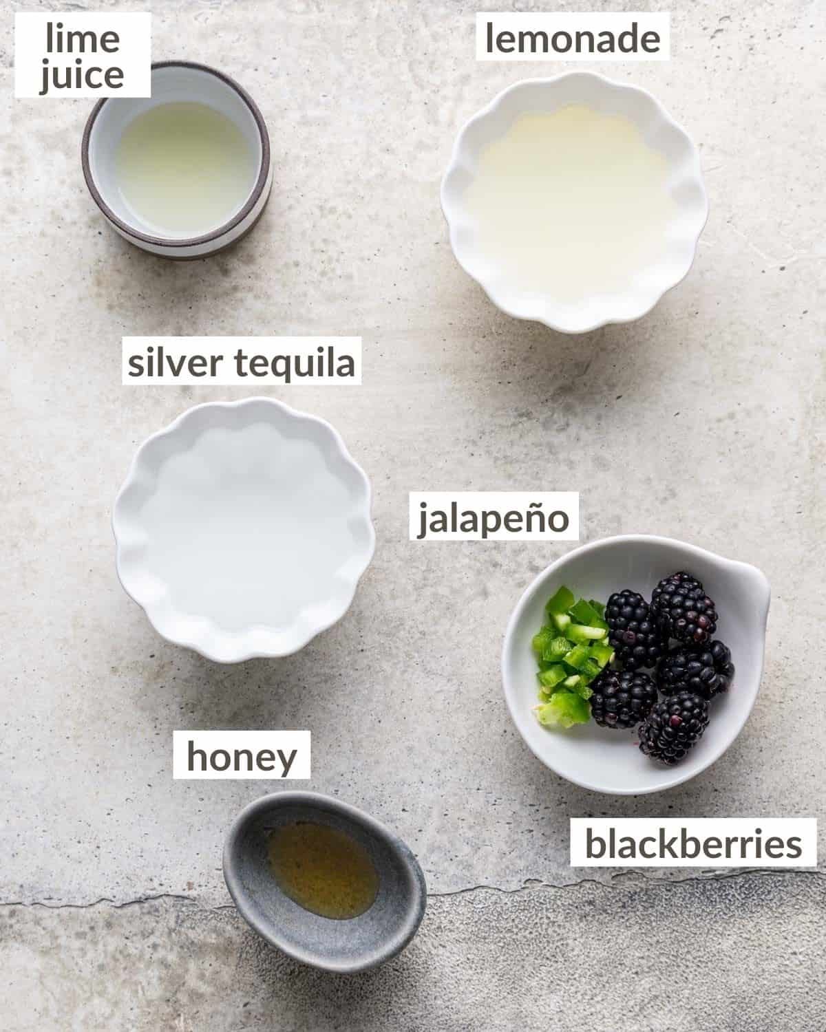 Overhead image of ingredients needed to make blackberry jalapeno margarita.