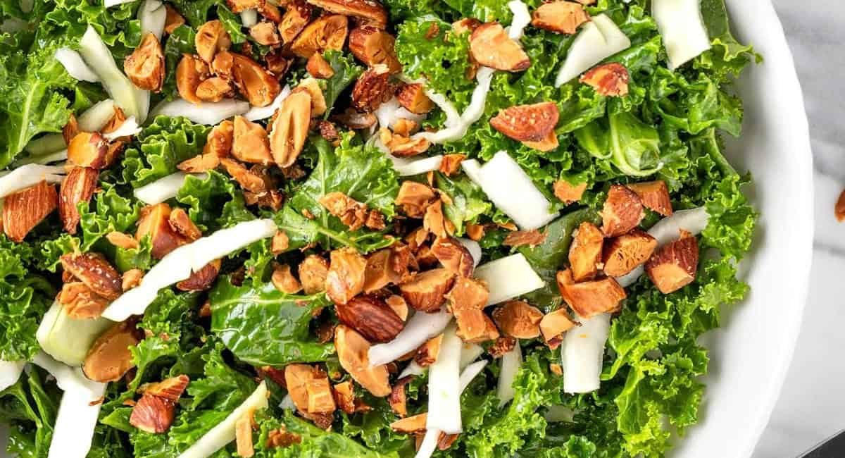 Overhead image of kale crunch salad in white bowl.