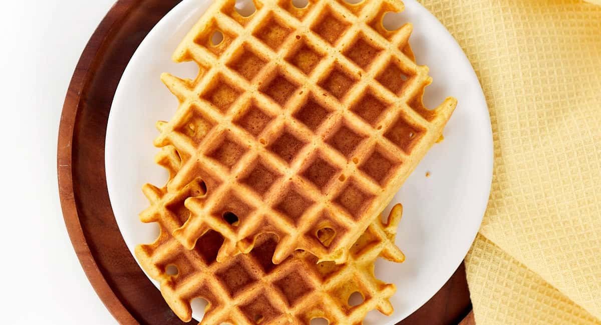 Overhead image of waffles on white dish.