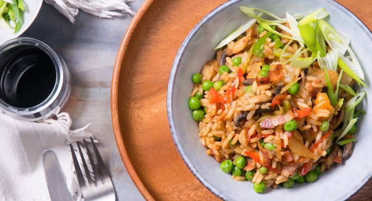Overhead image of kimchi bacon fried rice with garnish.