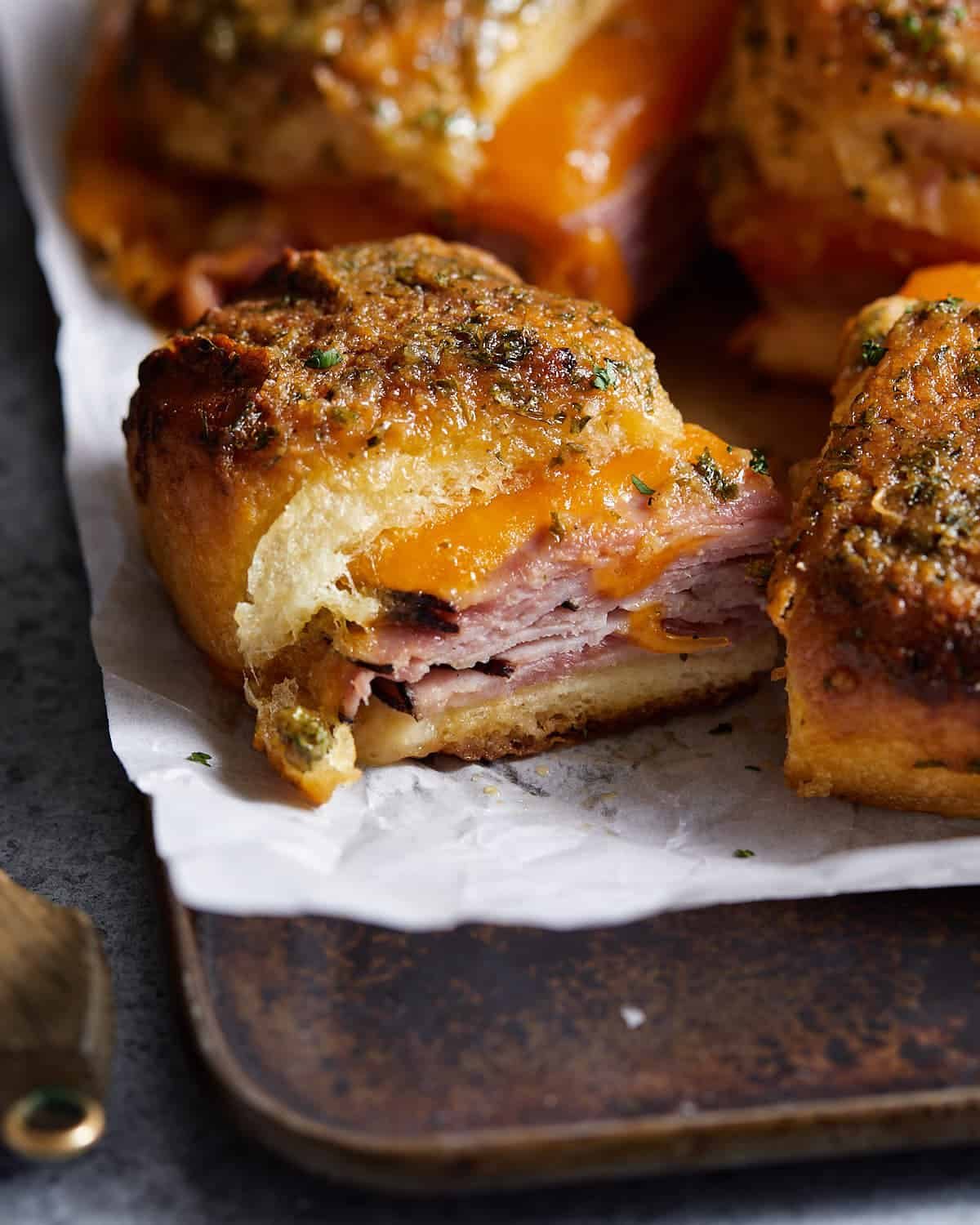 King's Hawaiian ham and cheese slide on parchment paper.