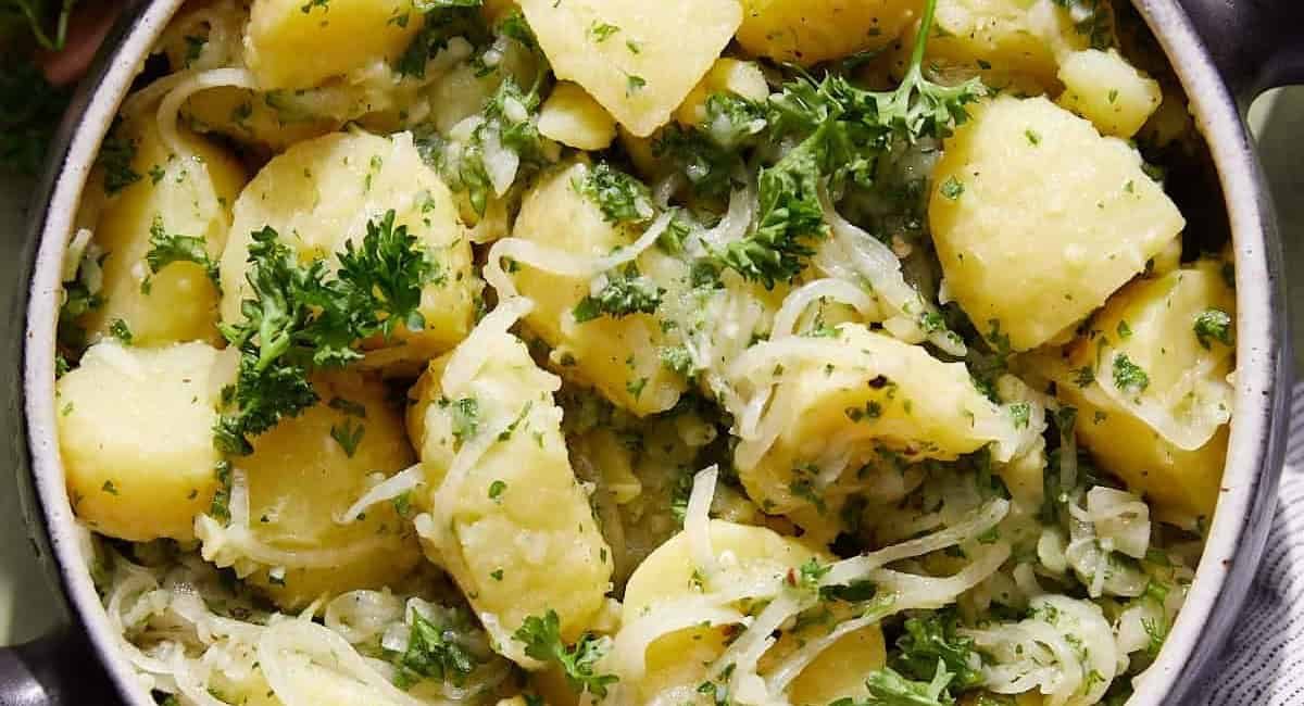 Overhead image of Lebanese potato salad in bowl with garnish.