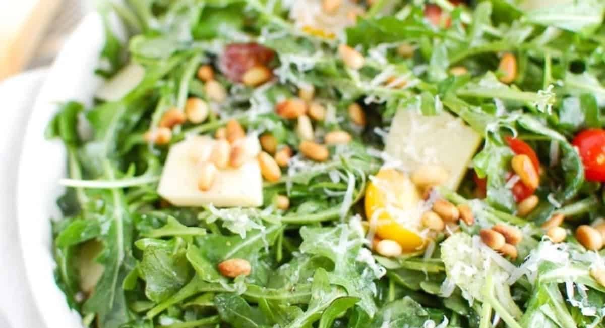 Up close image of lemon arugula sald with parmesan cheese.