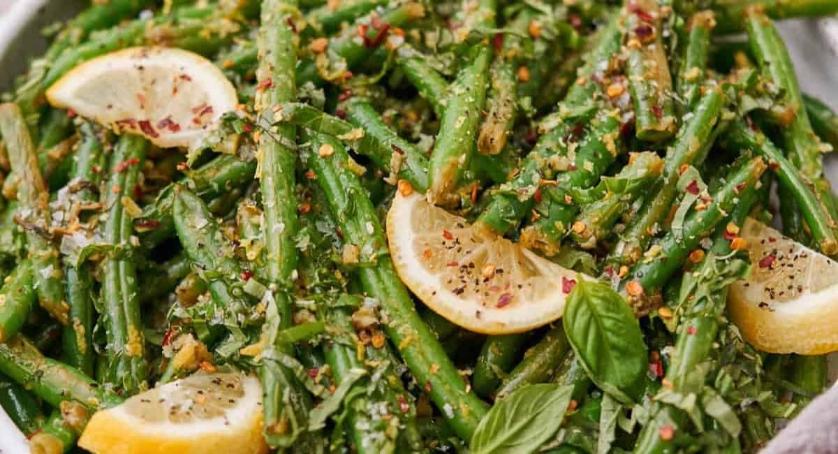 Overhead image of roasted green beans with garlic and lemon.