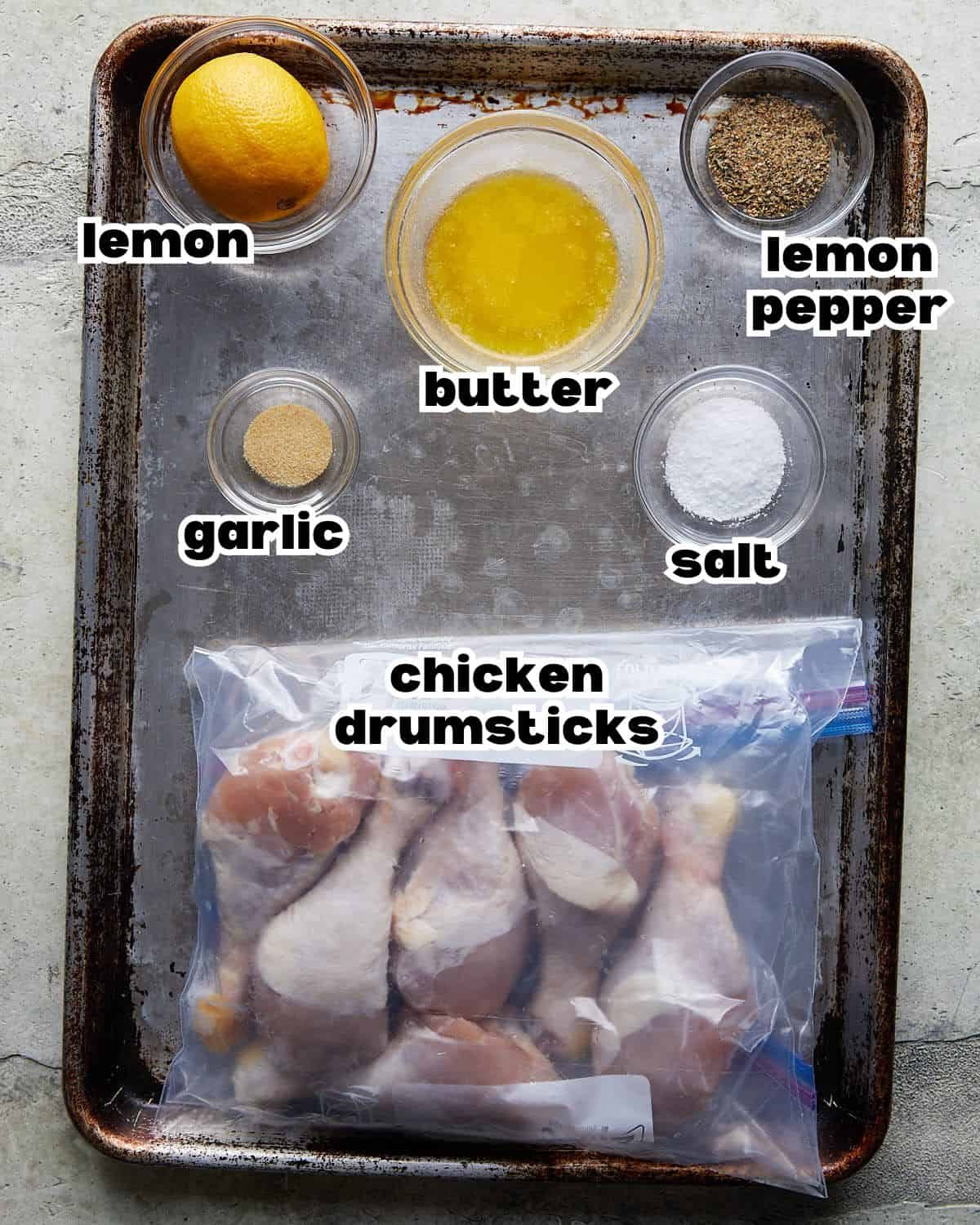 Overhead image ingredients needed to make lemon pepper chicken drumsticks.