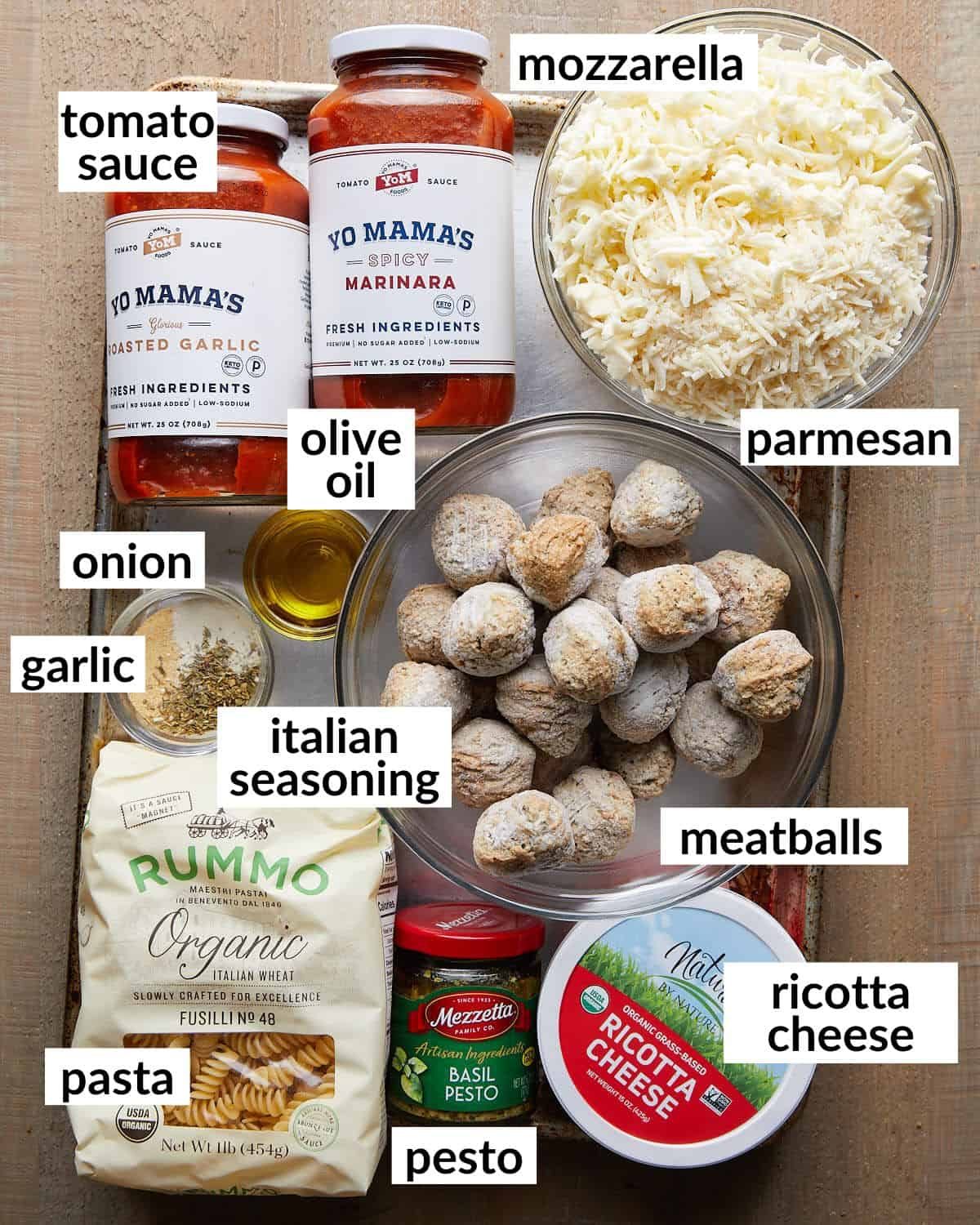 Overhead image of ingredients needed to make cheesy meatball pasta bake.