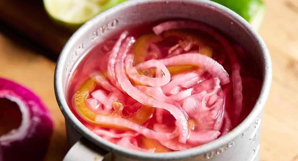Overhead up close image of Mexican pickled onions in silver cup.