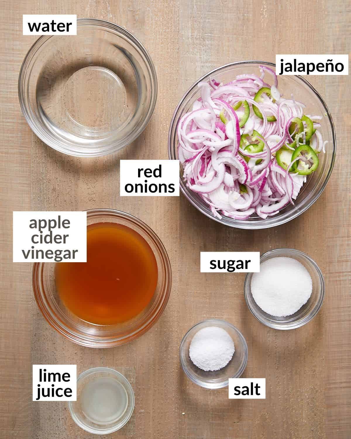 Ingredients needed to make mexican pickled onions in glass bowls.