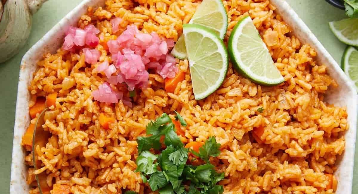 Overhead image of Mexican red rice with garnish.