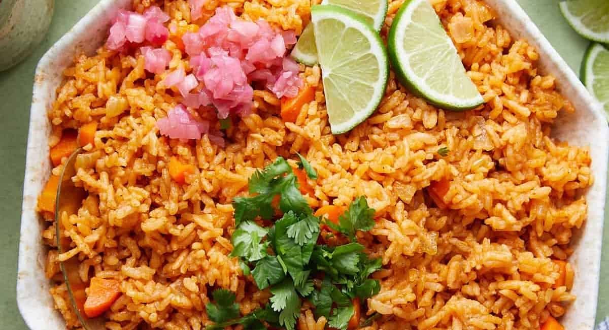 Overhead image of Mexican red rice with garnish.