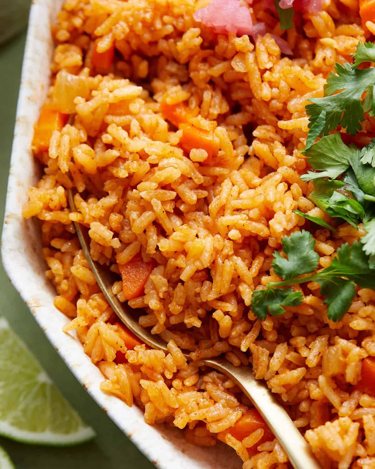 Up close overhead image of Mexican rice with garnish.
