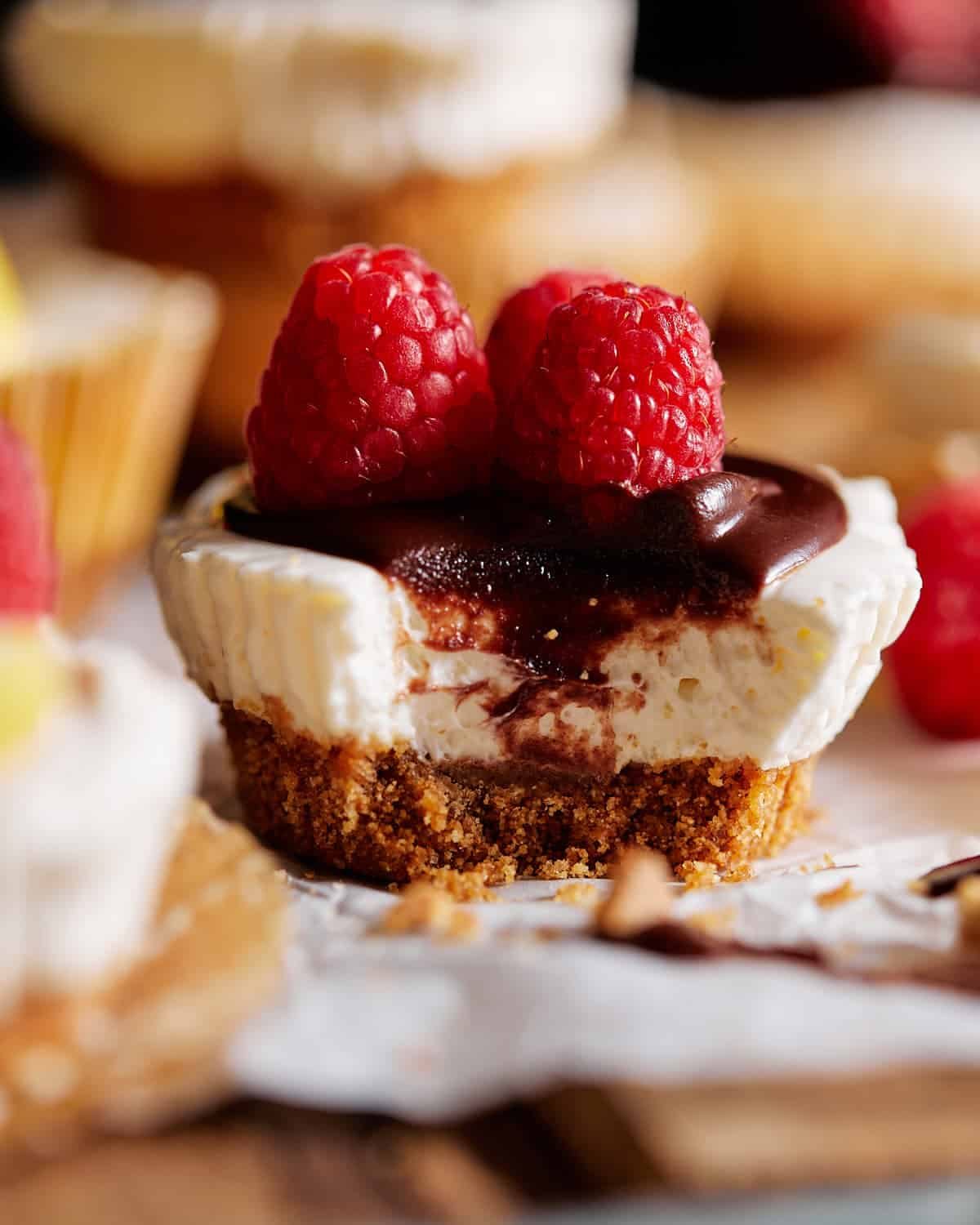 Mini no bake cheesecake with chocolate and raspberries on top.