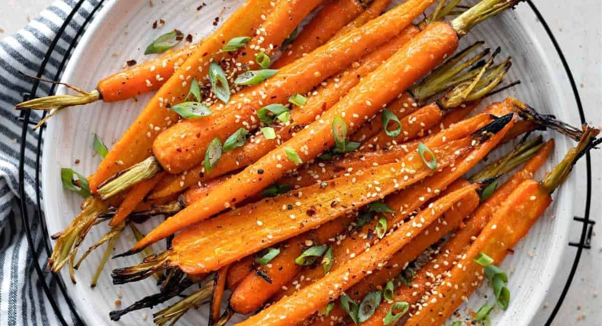 Overhead image of miso glazed carrots with garnish.