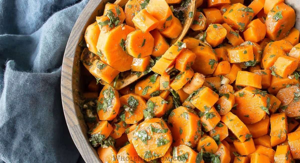 Overhead and upclose image of moroccan carrot salad in wooden bowl.