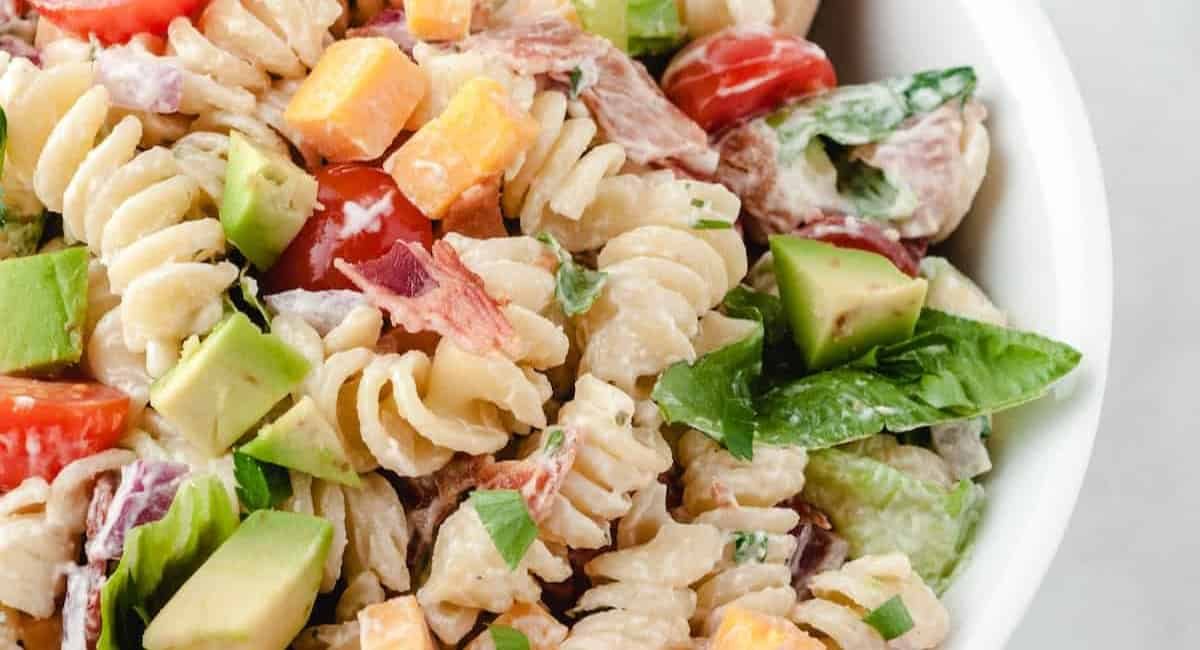 Up close image of blt pasta salad in white dish.