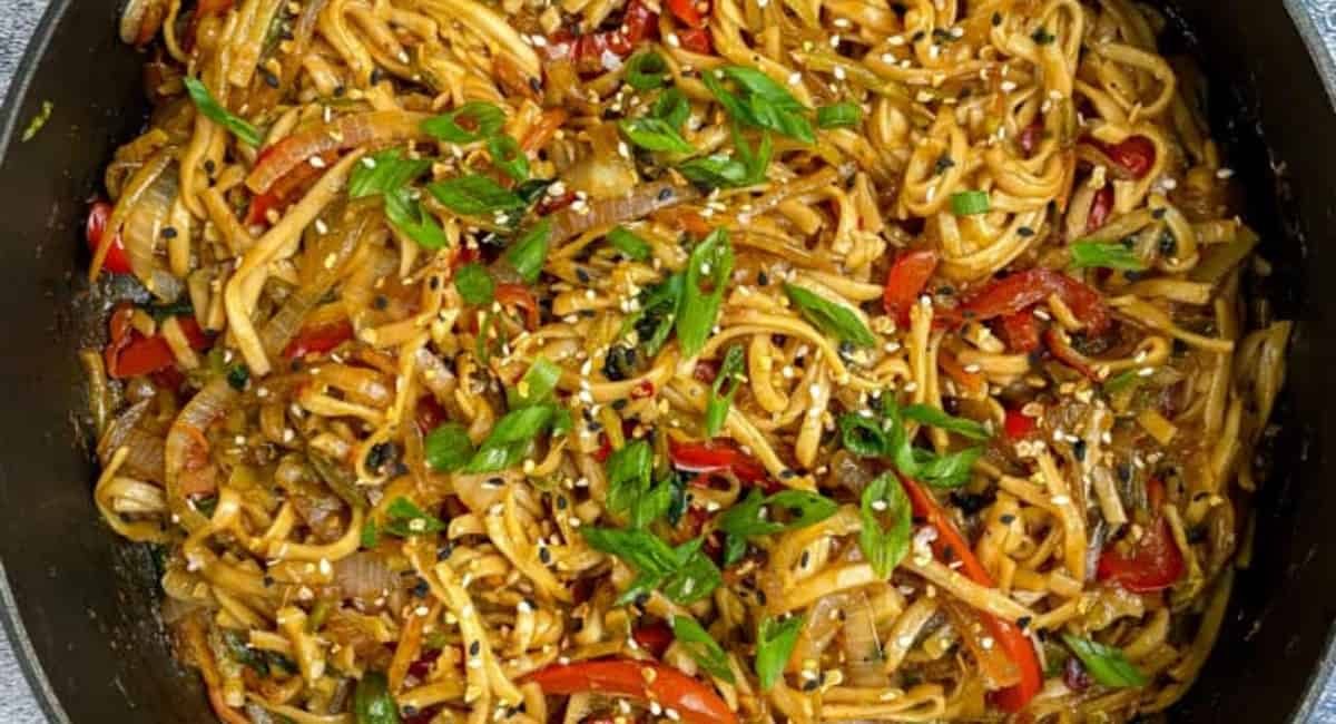 Overhead image of vegetable lo mein with garnish.