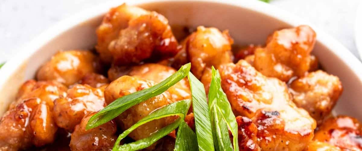 Honey butter chicken with garnish.