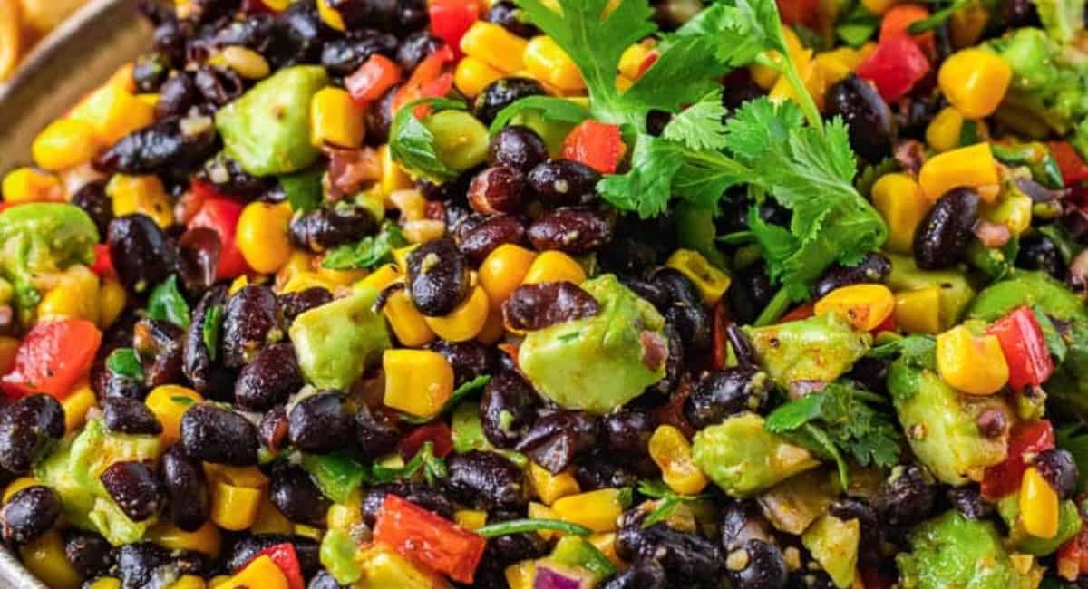 Up close image of corn and black bean salad with garnish.