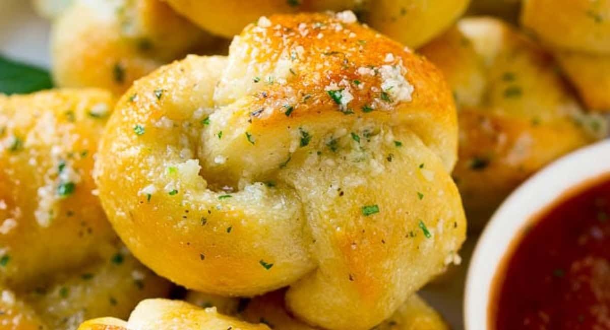 Up close image of garlic knot with garnish.