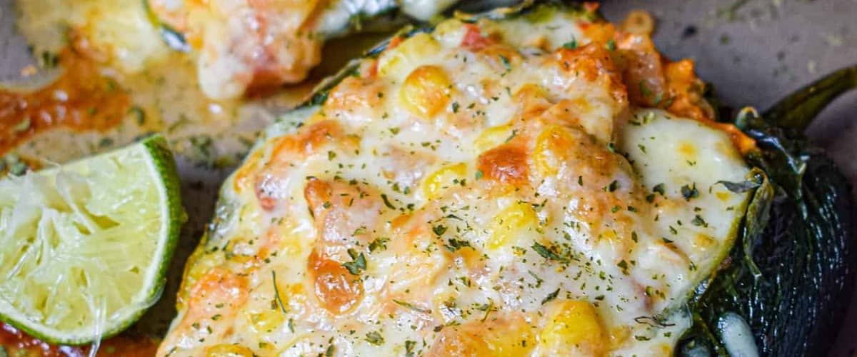 Chicken stuffed poblano peppers with lime and garnish.