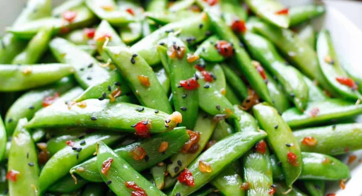 Up close image of sugar snap peas with garnish.