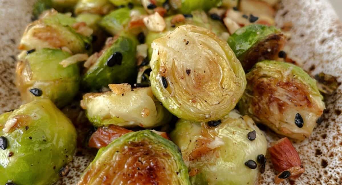 Up close image of pan fried brussels sprouts with almonds.