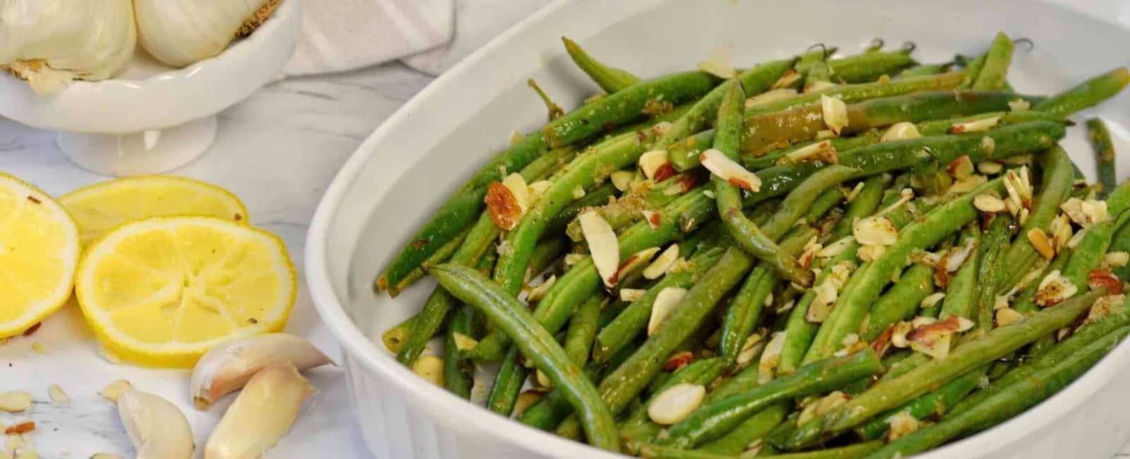 Up close image of garlic roasted greens beans with almonds.