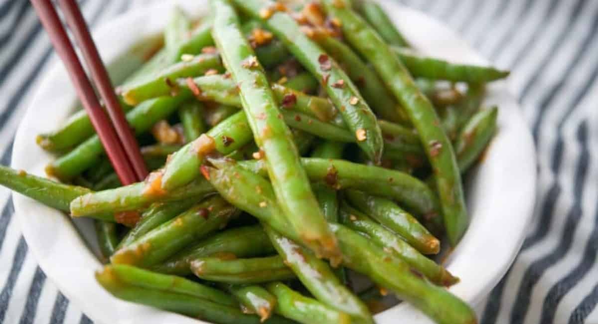 Overhead image of chili garlic green beans with garnish.