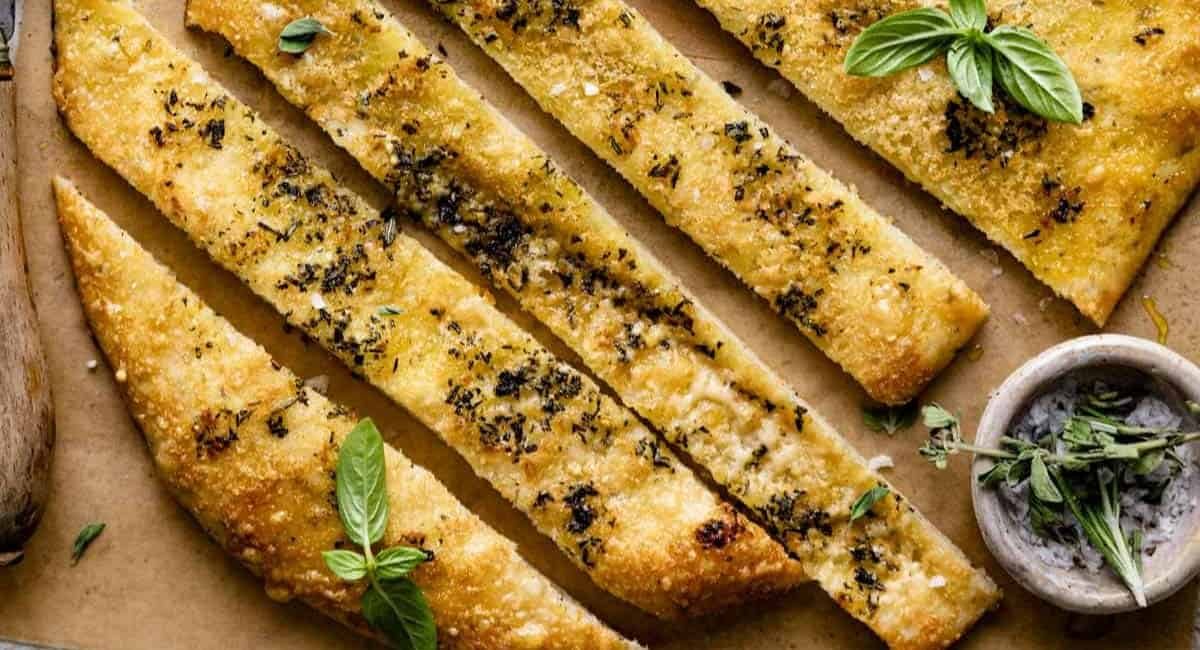 Overhead image of rosemary parmesan bread with garnish.
