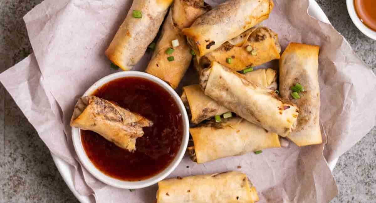Overhead image of vegetable lumpia with sauce.
