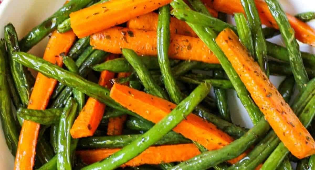 Overhead image of roasted green beans and caarrots.