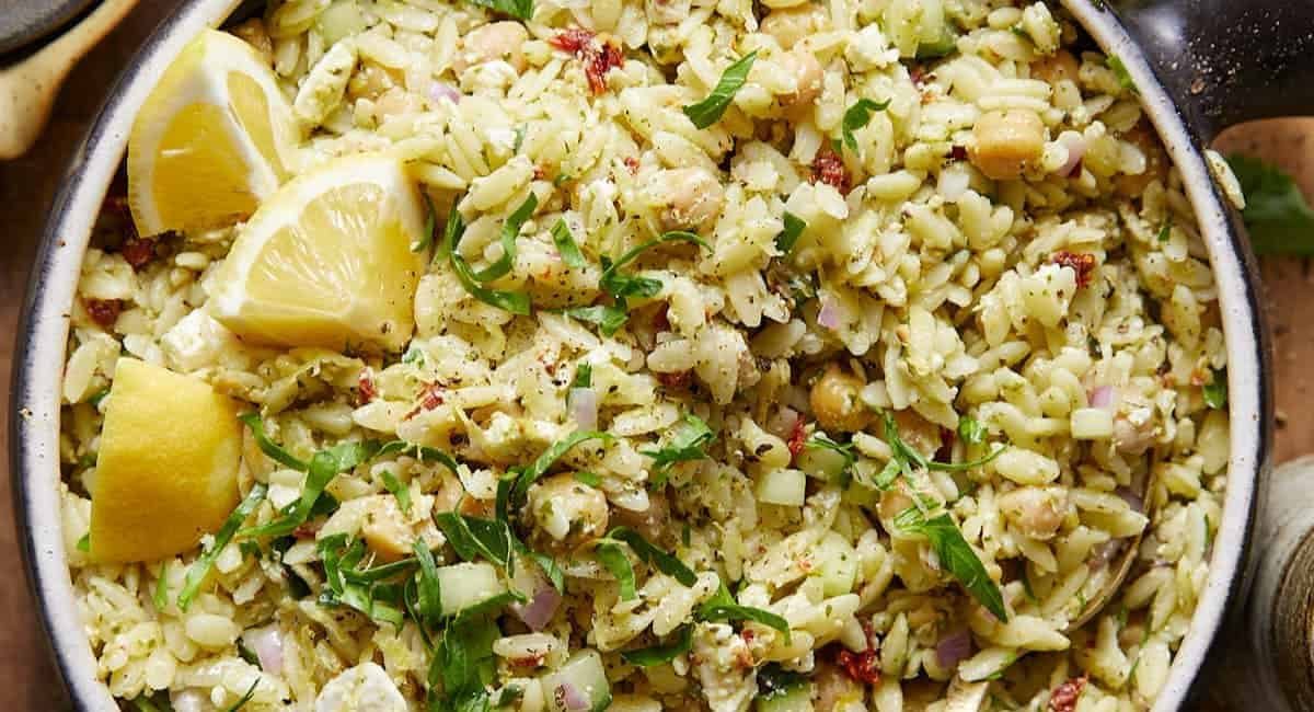 Overhead image of pesto orzo salad with garnish.