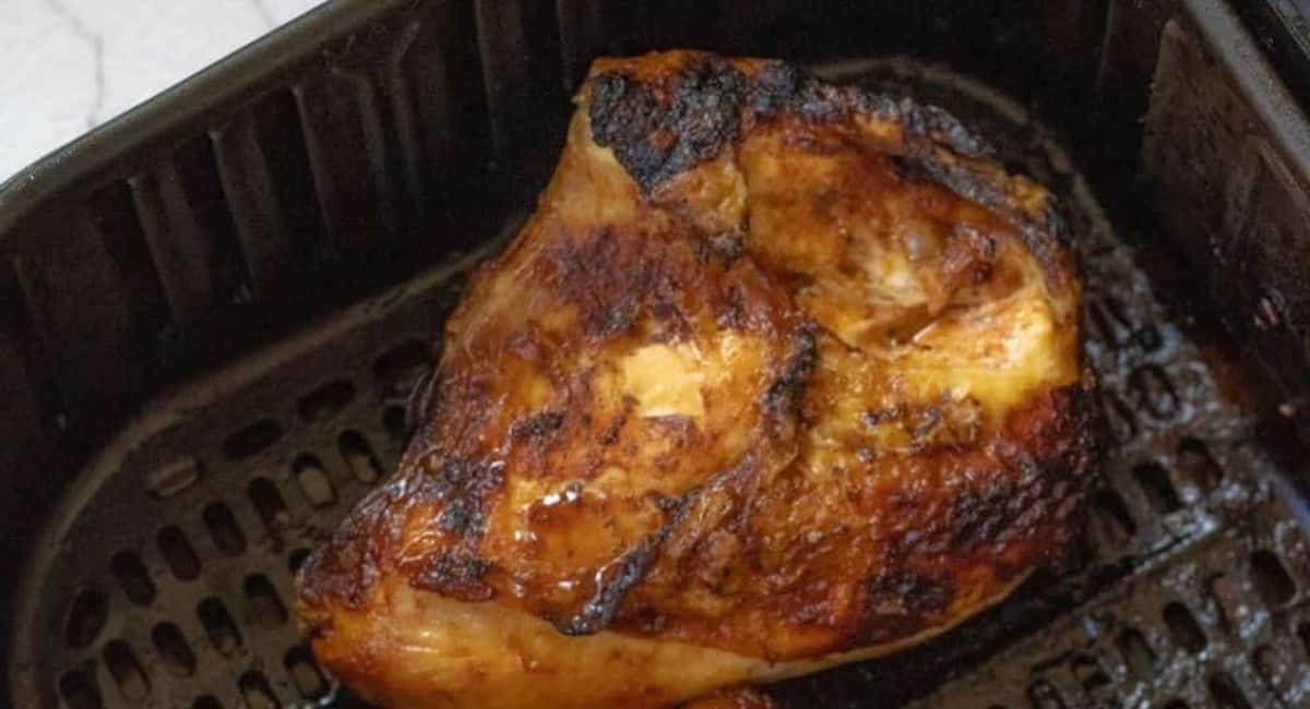 Overhead image of air fryer bone in chicken breasts.