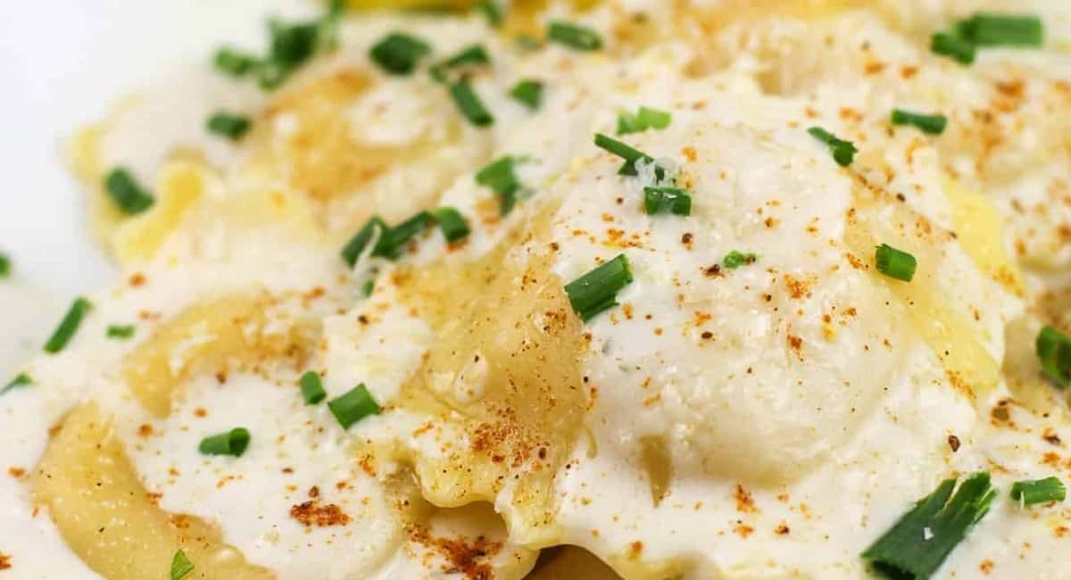 Up close image of lemon garlic cream sauce for lobster ravioli.