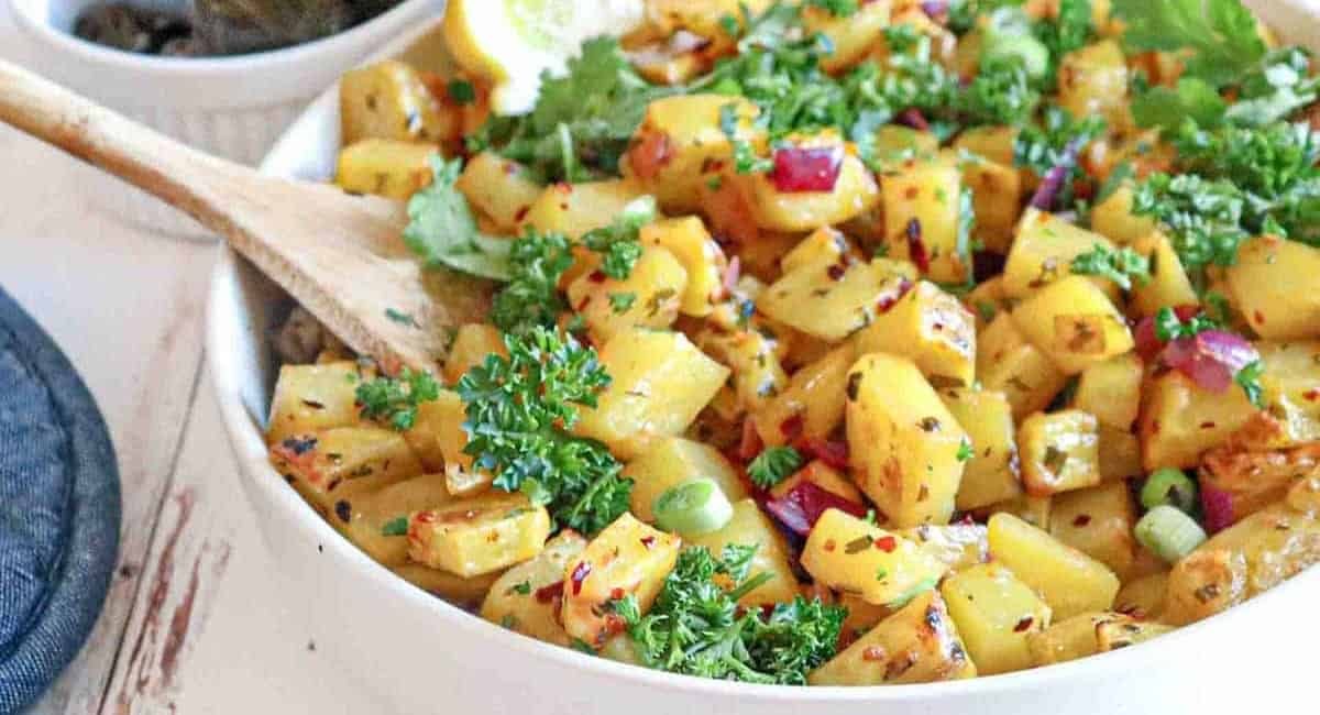 Up close image of batata harra with garnish.