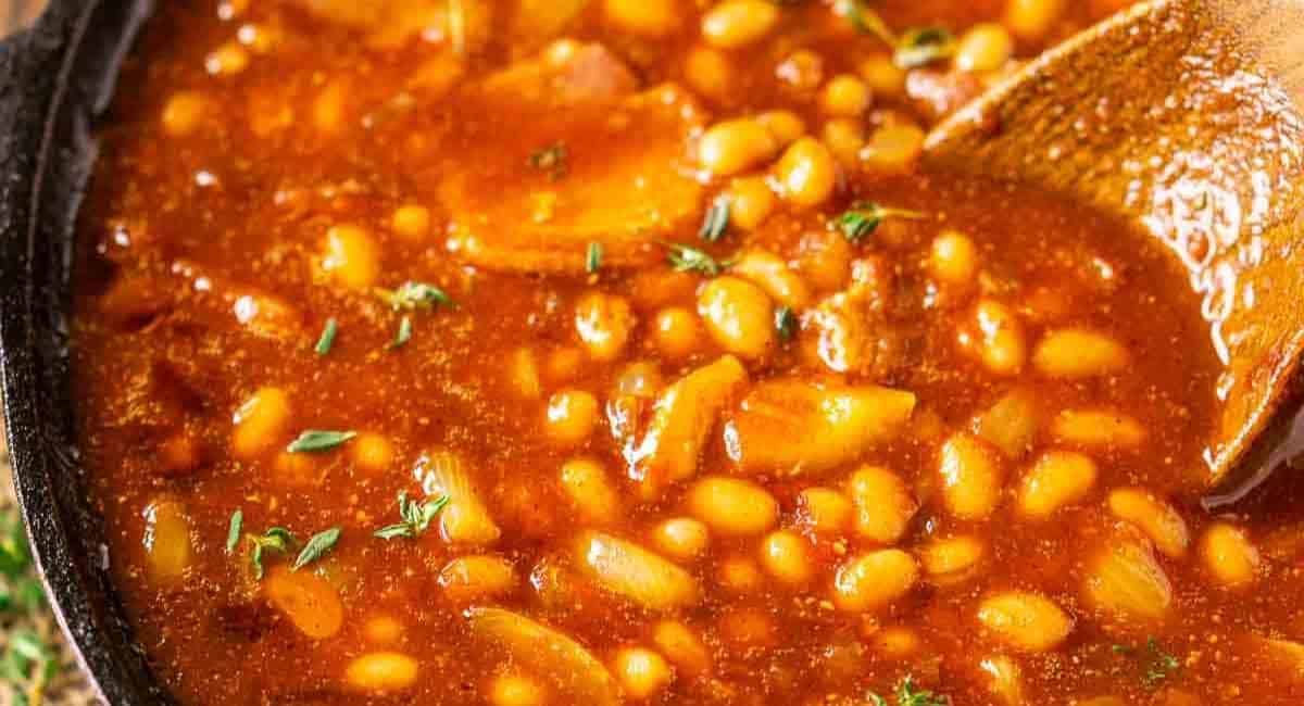Up close image of smoked baked beans with garnish.