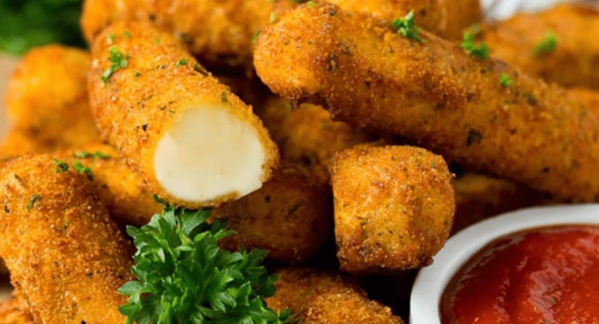 Up close image of mozzarella sticks with garnish.