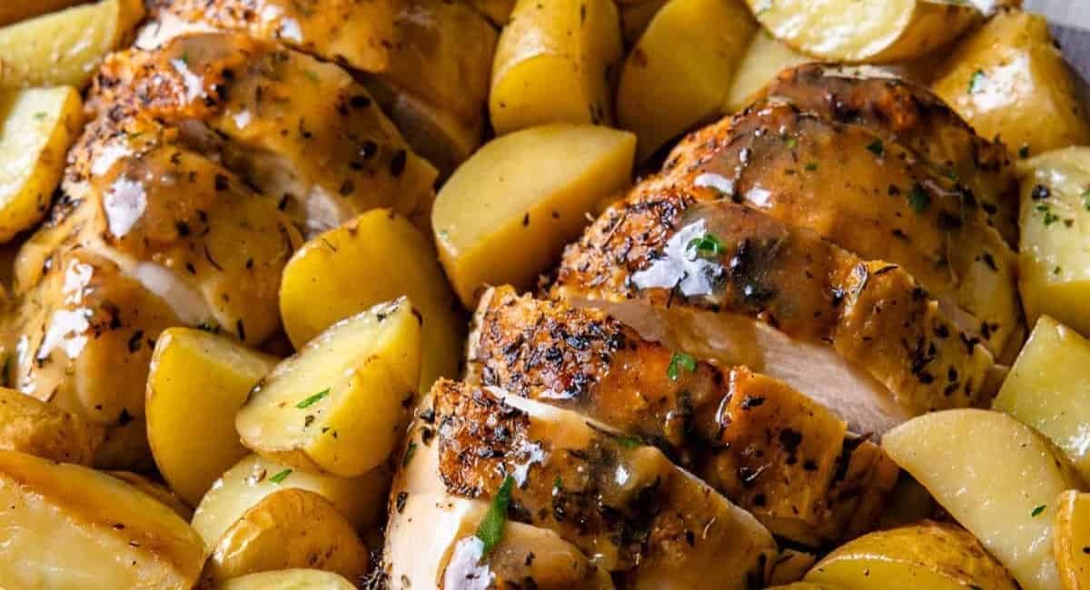 Up close image of roasted cast iron chicken breasts and potatoes.